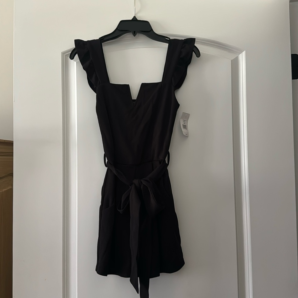 Black romper with ruffle sleeves
